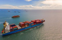 Container ship in export and import business and logistics in the ocean. Water transport International. Aerial view